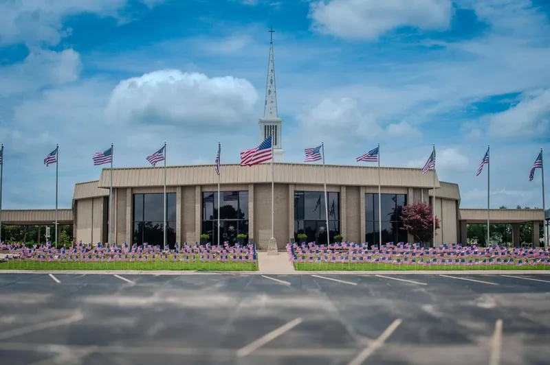 The front of the Immanuel Fellowship Church building in Seminole with a row of flags out front